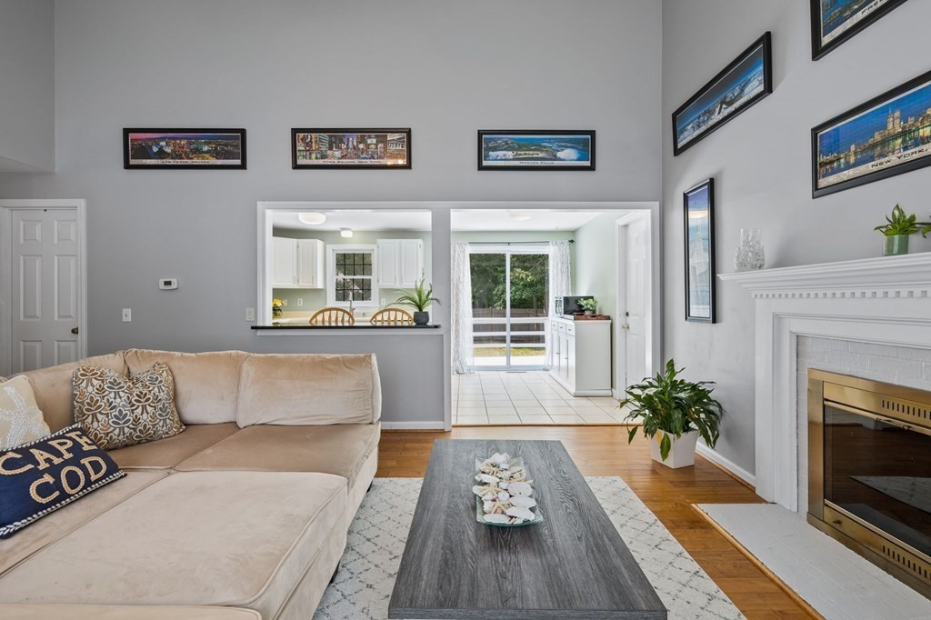 225 Skunknet Road Barnstable, MA 02632 - Photo 6 of 27 a living room with furniture and a fireplace