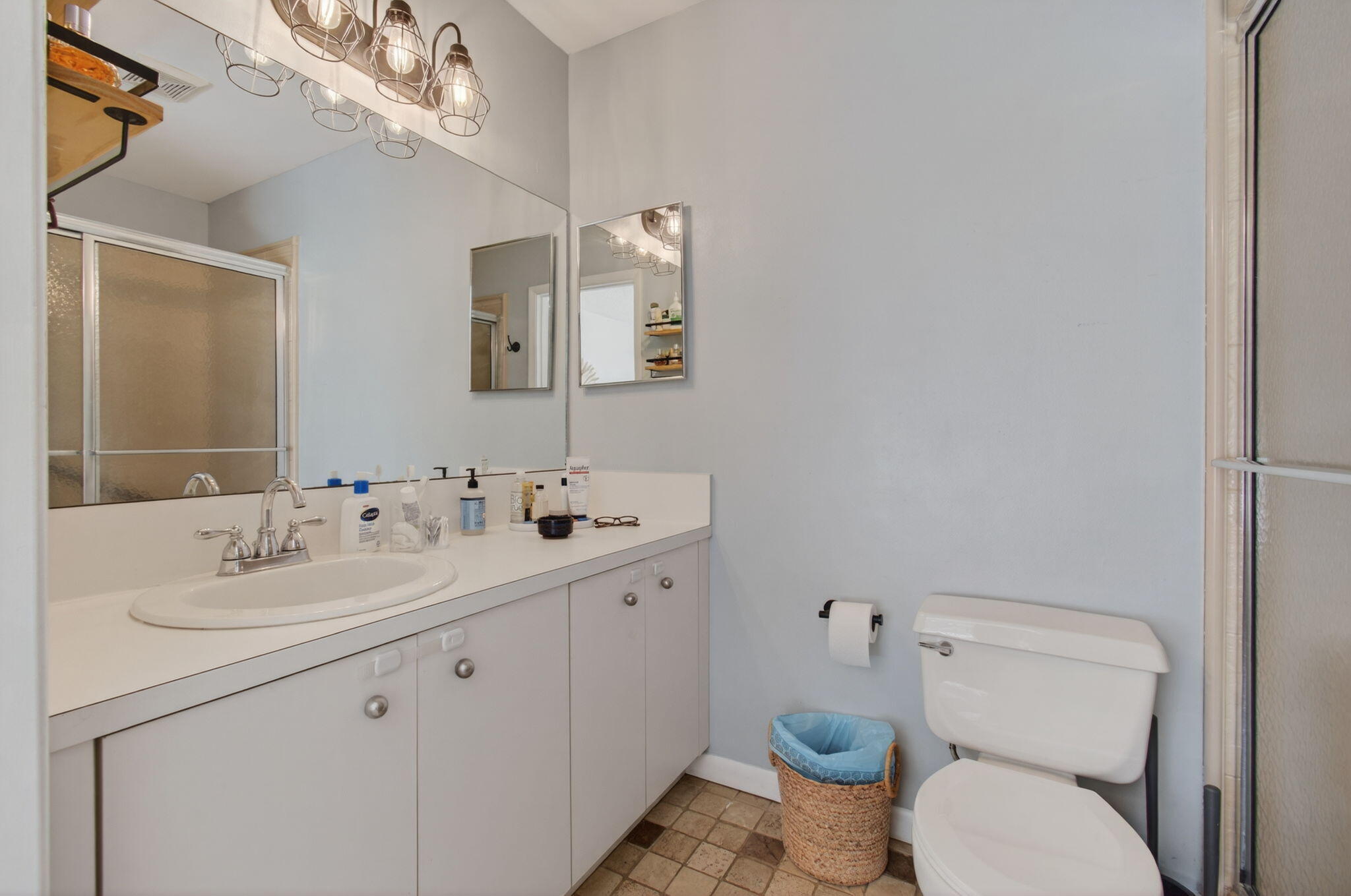 9931 Kamena Circle Boynton Beach, FL 33436 - Photo 20 of 37 a bathroom with a toilet sink and mirror