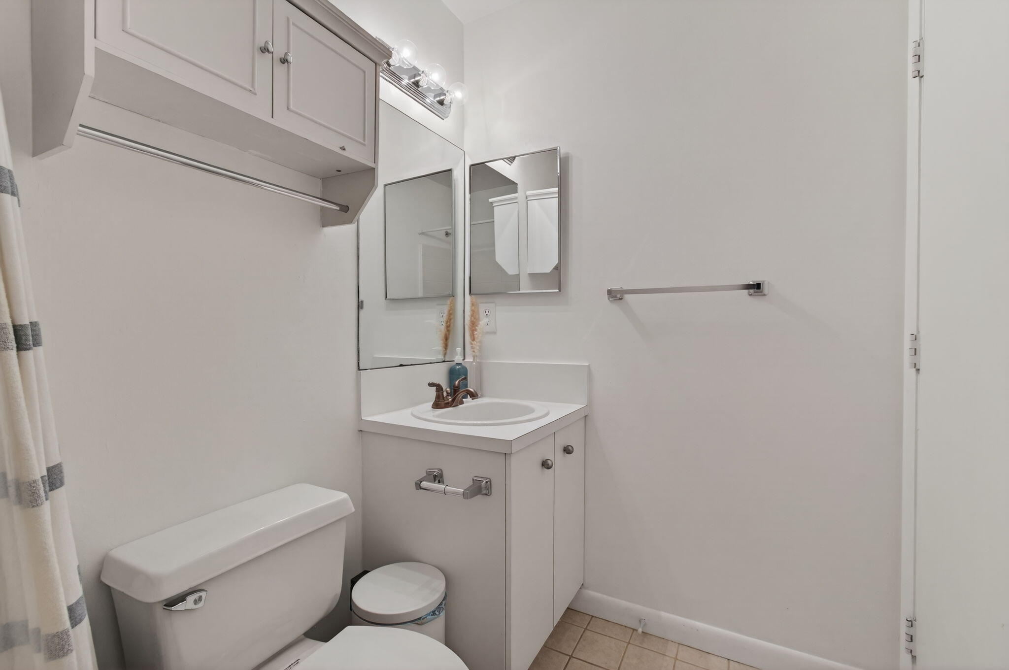 9931 Kamena Circle Boynton Beach, FL 33436 - Photo 27 of 37 a bathroom with a toilet sink and mirror