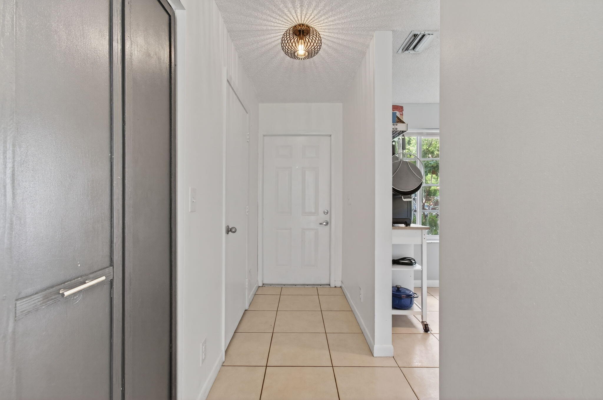 9931 Kamena Circle Boynton Beach, FL 33436 - Photo 3 of 37 a view of a hallway with closet and front door