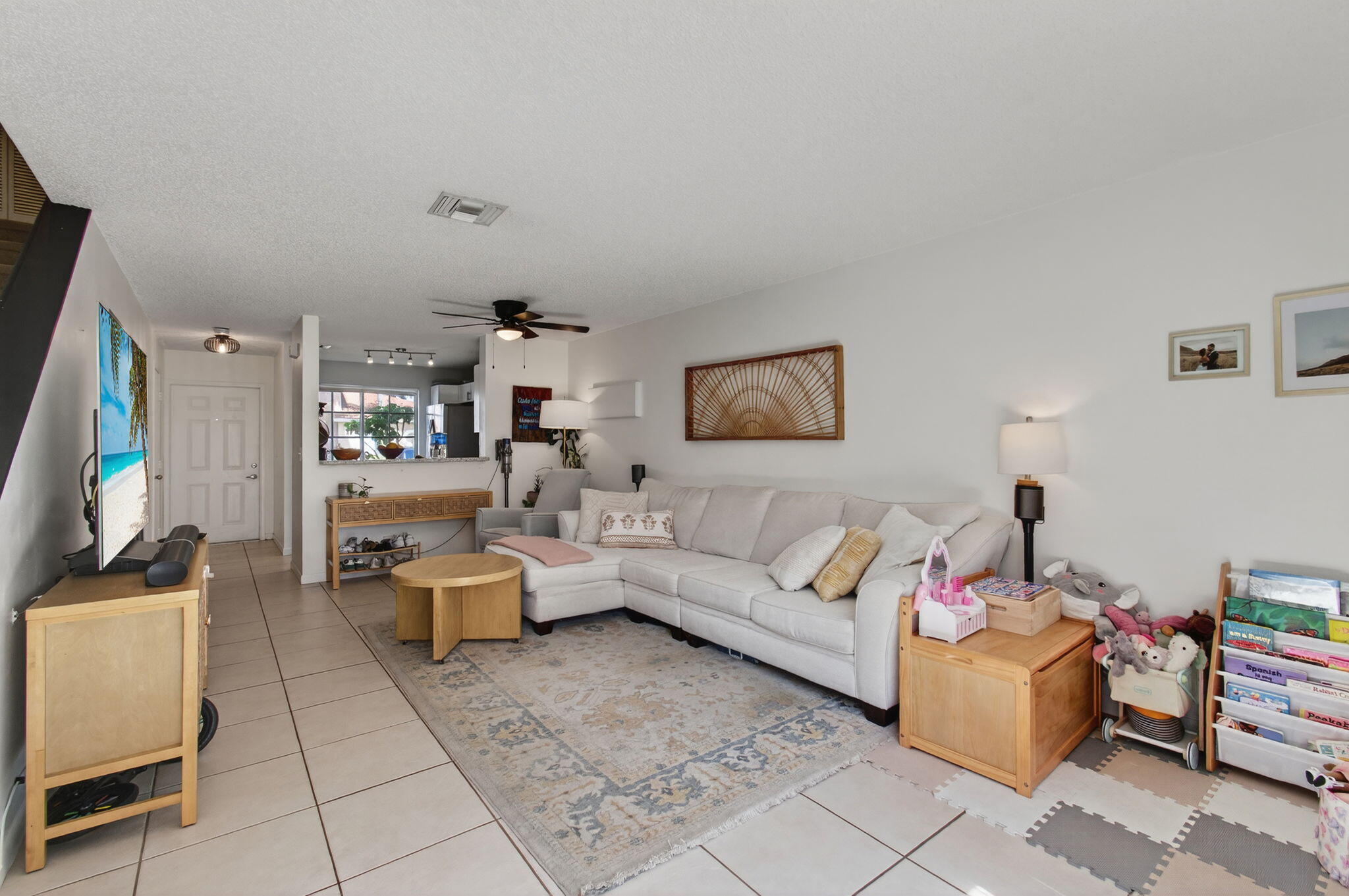 9931 Kamena Circle Boynton Beach, FL 33436 - Photo 8 of 37 a living room with furniture a flat screen tv and a table