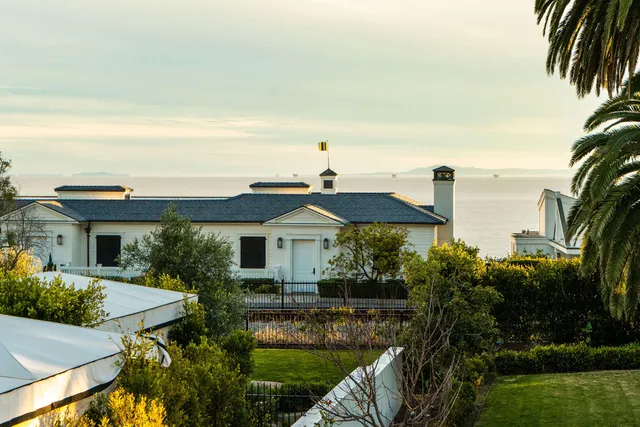 a front view of house with a garden