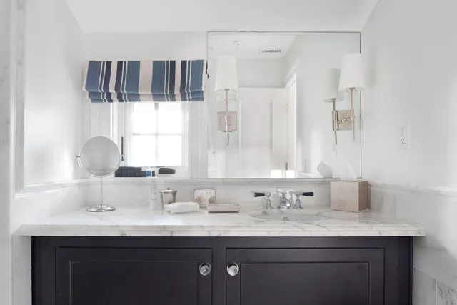 a bathroom with a sink double vanity and mirror