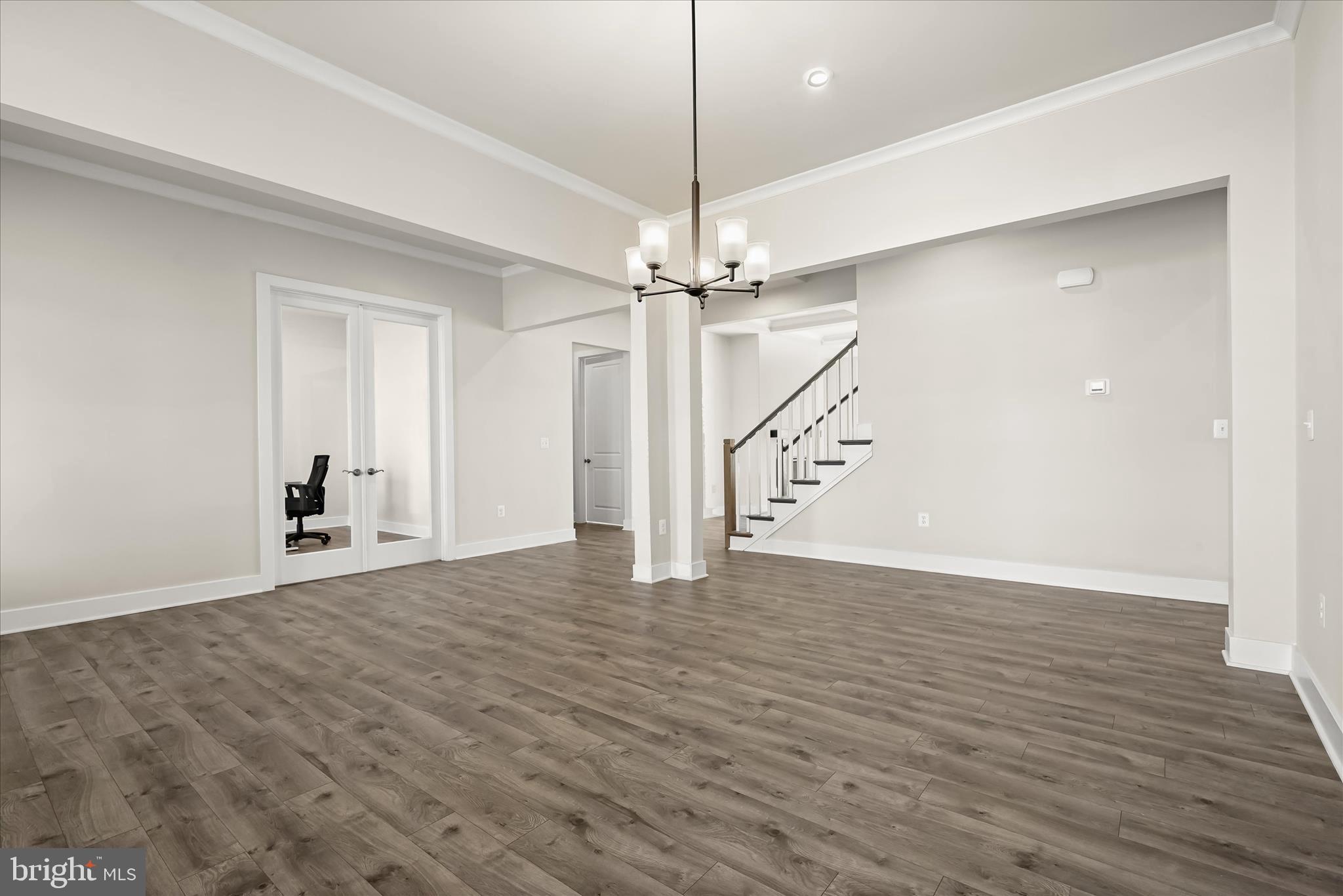 7306 Sugar Magnolia Loop Gainesville, VA 20155 - Photo 12 of 71 a view of a livingroom with wooden floor stairs and a ceiling fan