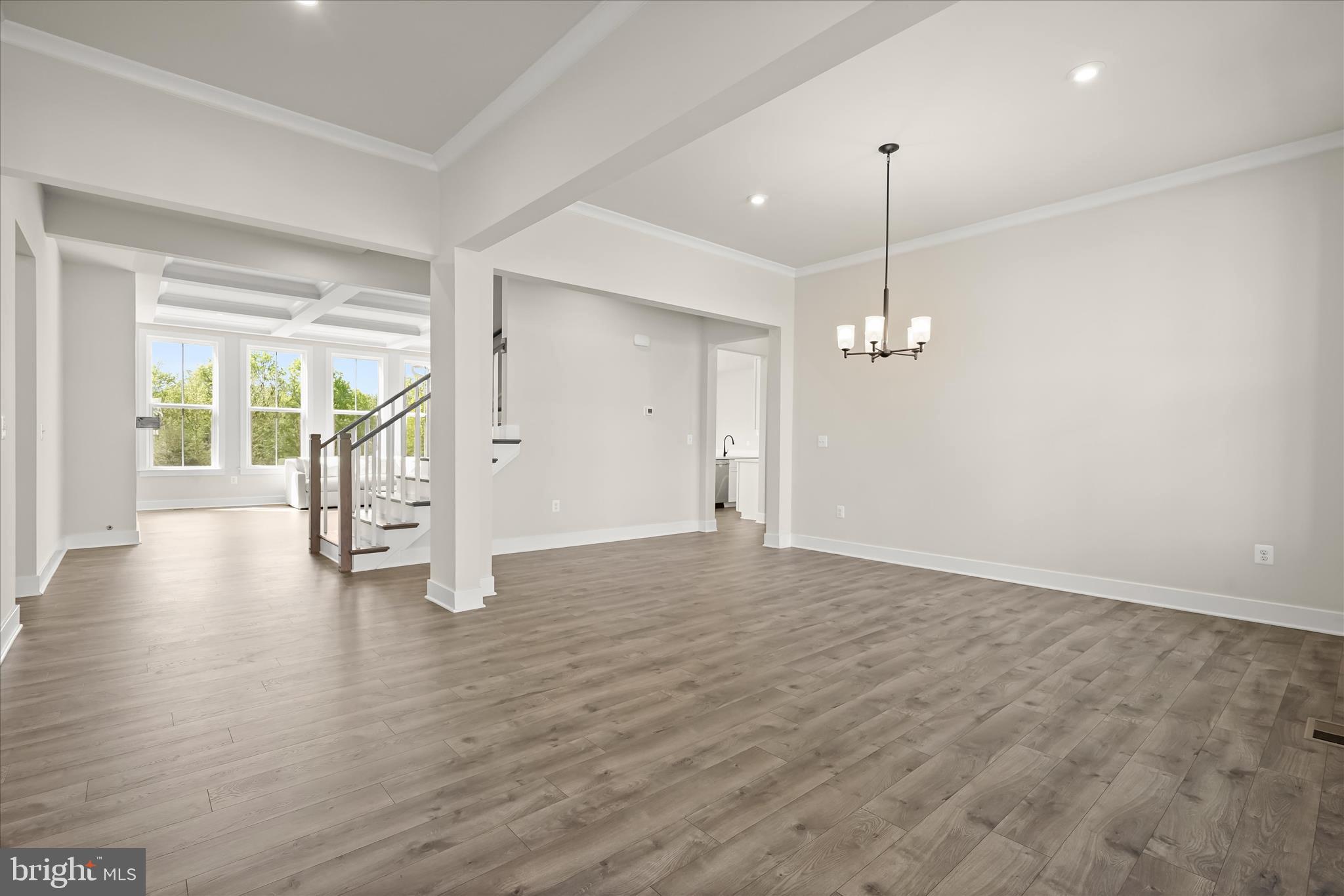 7306 Sugar Magnolia Loop Gainesville, VA 20155 - Photo 14 of 71 a view of an empty room with wooden floor and a window
