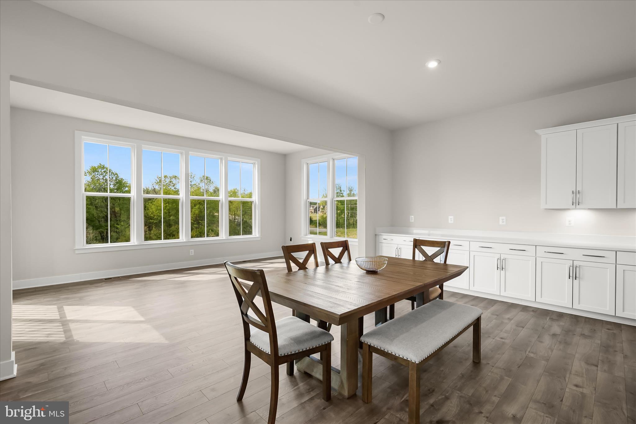 7306 Sugar Magnolia Loop Gainesville, VA 20155 - Photo 67 of 71 a view of a dining room with furniture and wooden floor