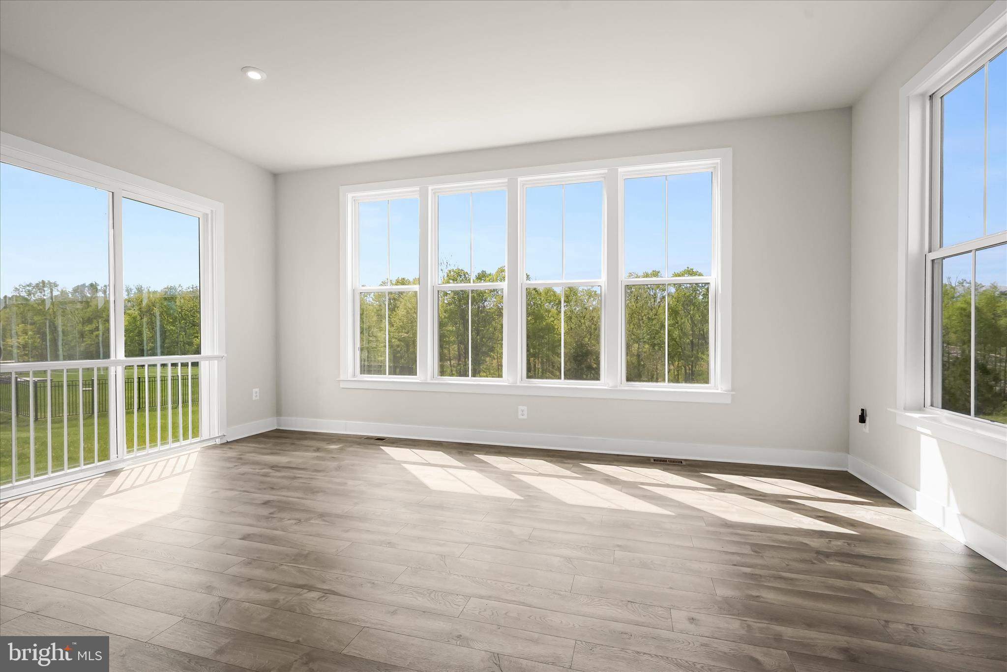 7306 Sugar Magnolia Loop Gainesville, VA 20155 - Photo 25 of 71 a view of an empty room with wooden floor and a window