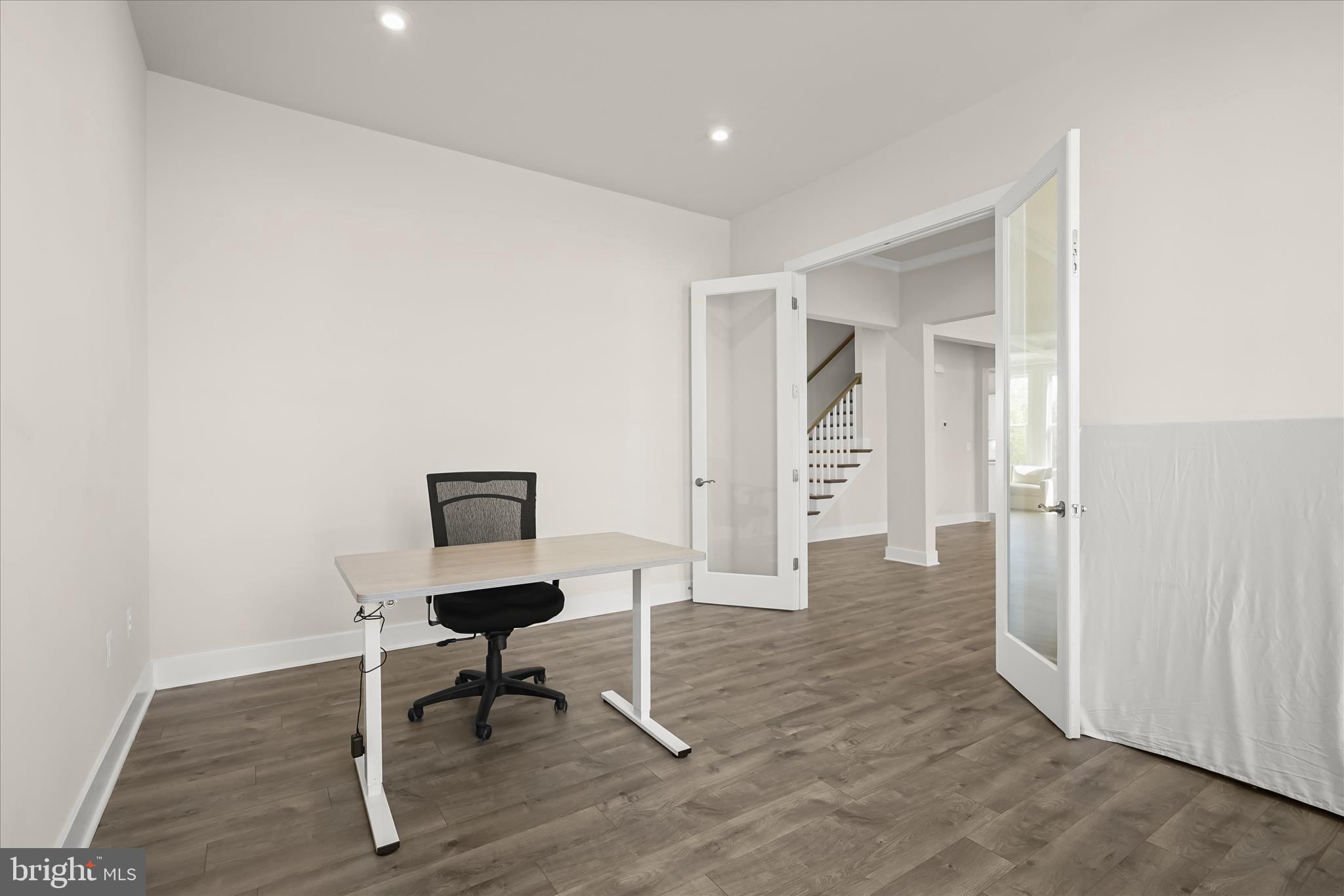 7306 Sugar Magnolia Loop Gainesville, VA 20155 - Photo 27 of 71 a view of a hallway with wooden floor and a workspace