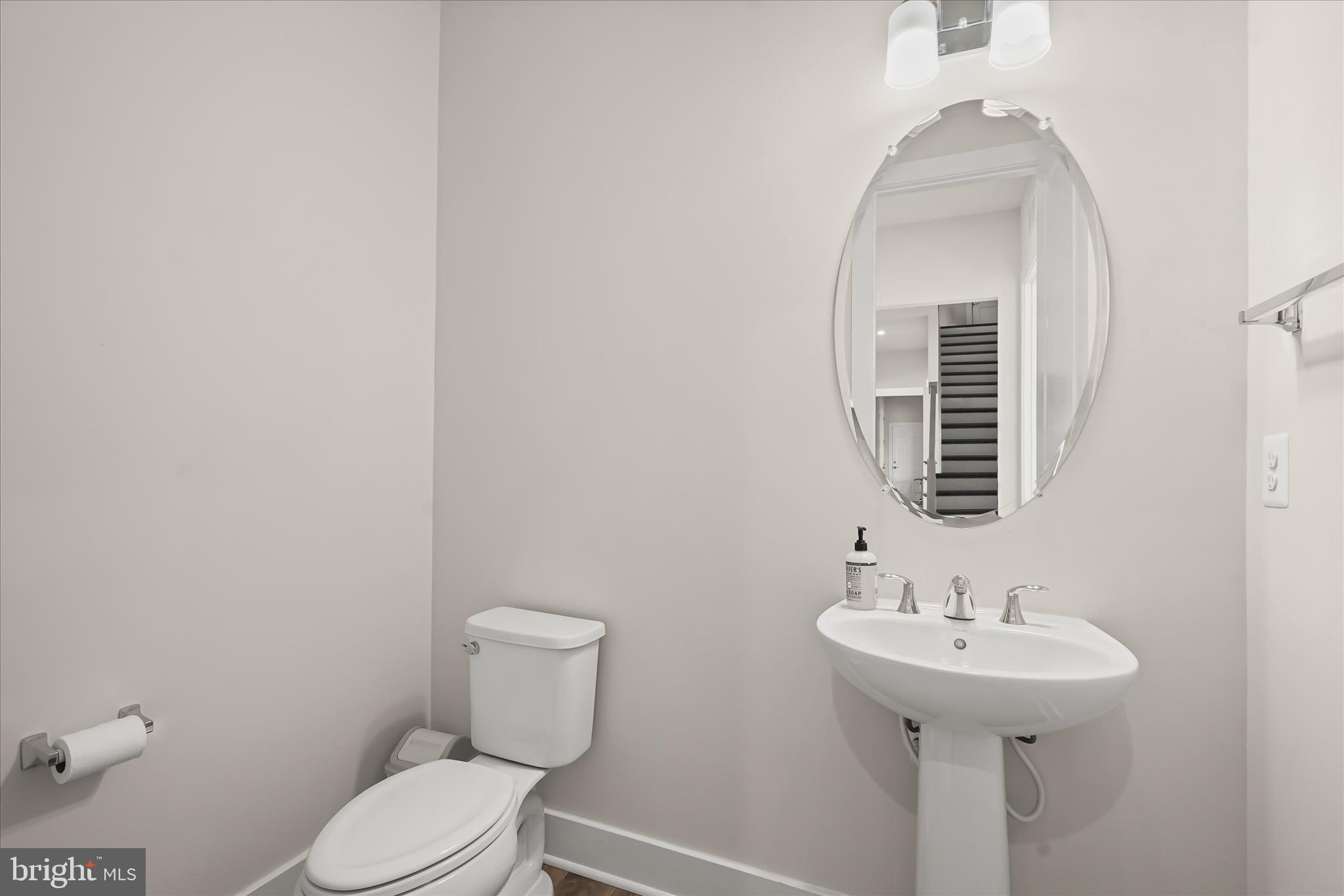 7306 Sugar Magnolia Loop Gainesville, VA 20155 - Photo 31 of 71 a bathroom with a sink a toilet and mirror
