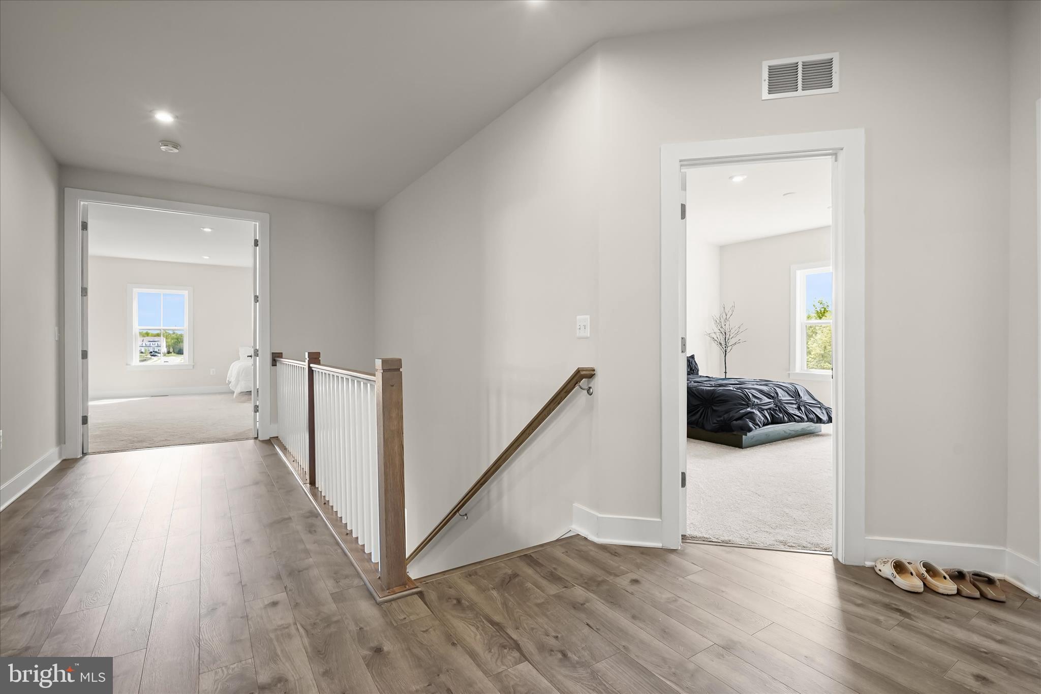 7306 Sugar Magnolia Loop Gainesville, VA 20155 - Photo 32 of 71 a view of a hallway with a wooden floor and a living room