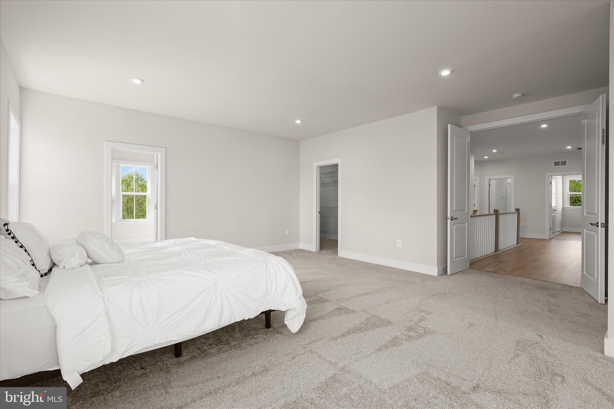 7306 Sugar Magnolia Loop Gainesville, VA 20155 - Photo 33 of 71 a spacious bedroom with a bed and a chandelier
