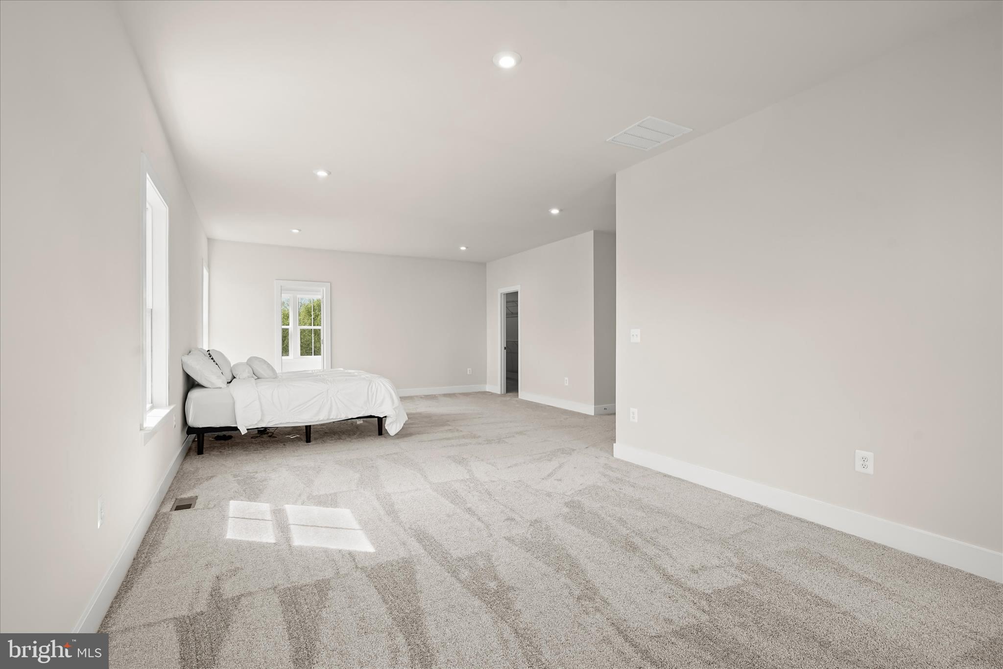 7306 Sugar Magnolia Loop Gainesville, VA 20155 - Photo 36 of 71 a view of a bedroom with a bed and a window