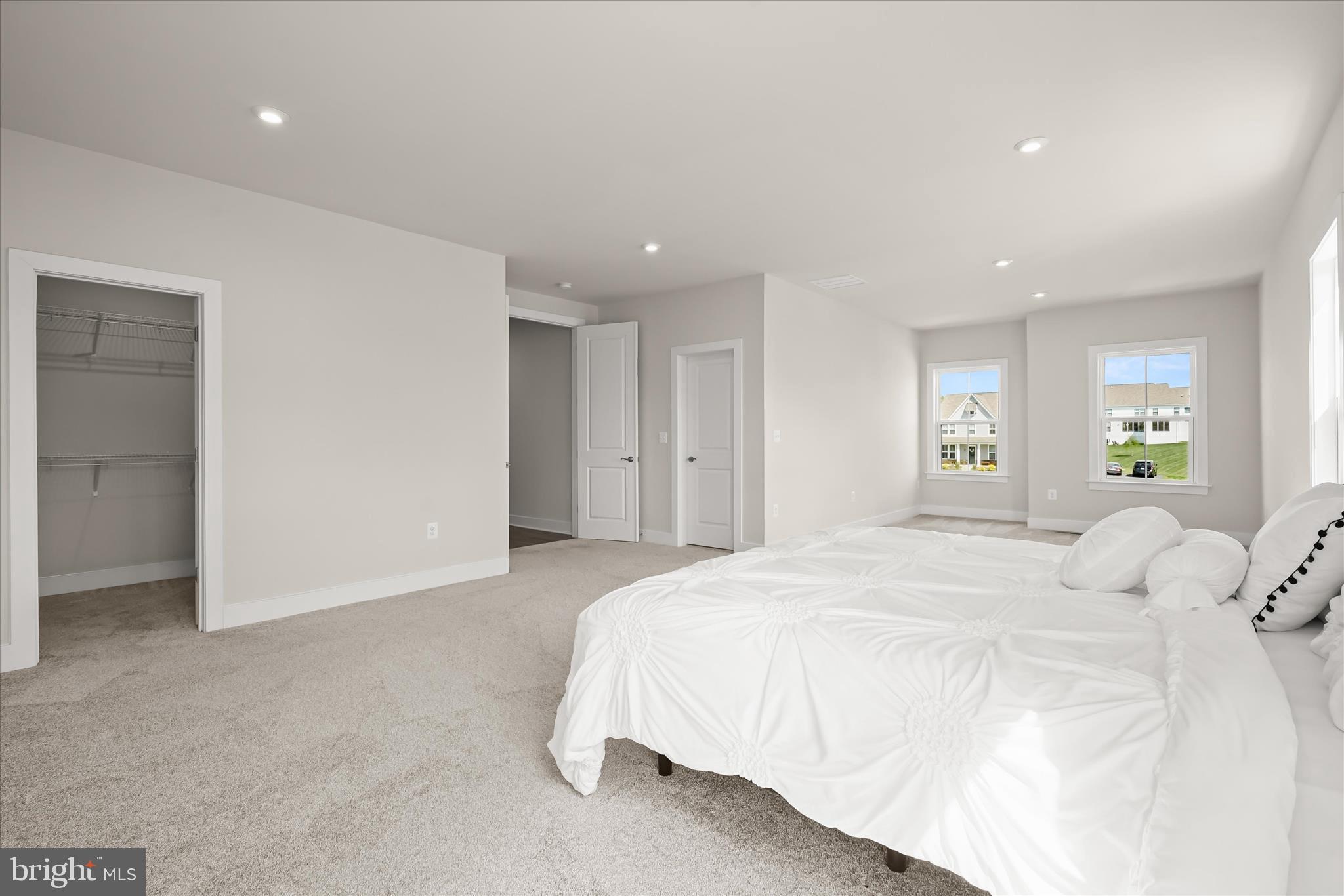 7306 Sugar Magnolia Loop Gainesville, VA 20155 - Photo 37 of 71 a spacious bedroom with a bed and a couch