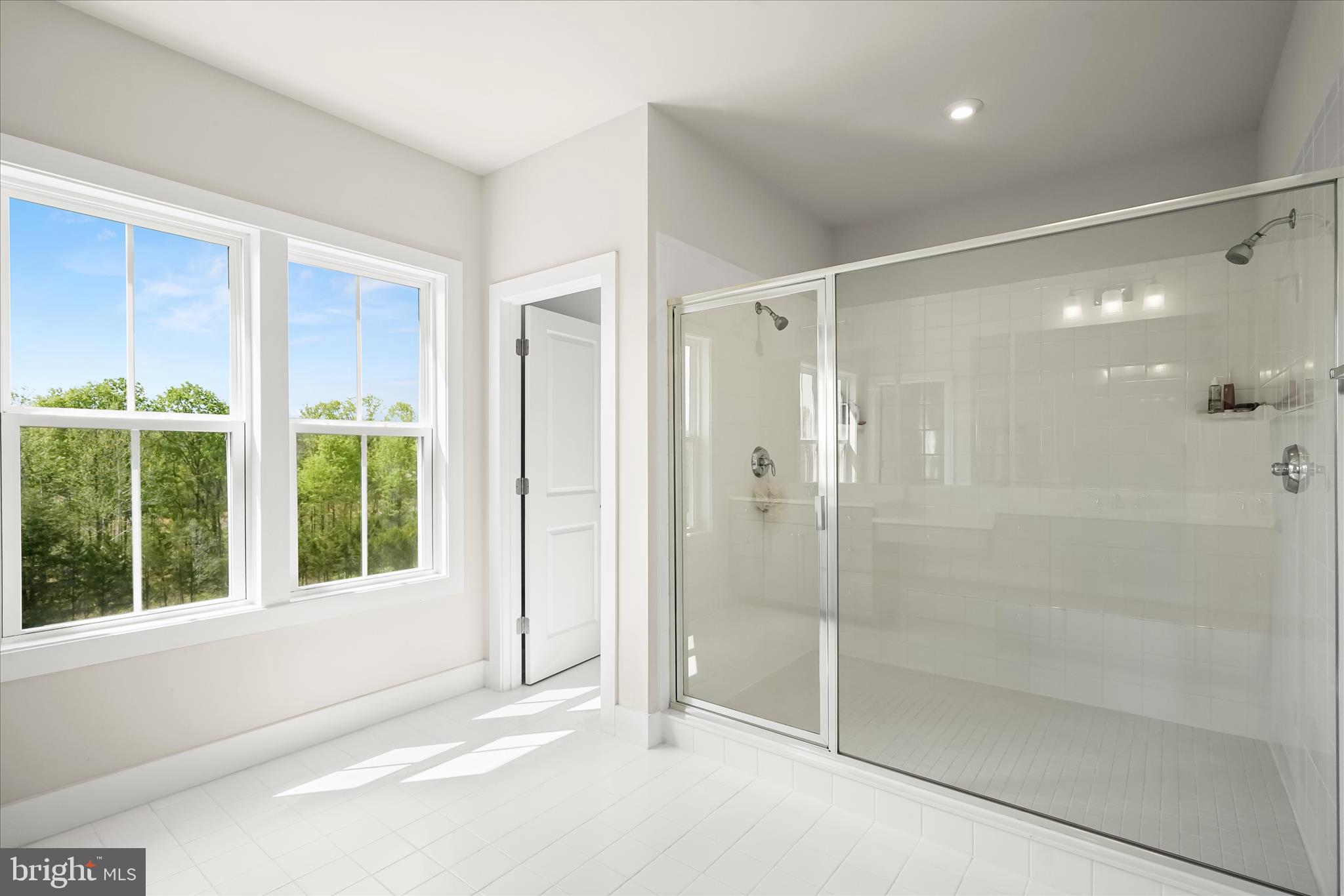 7306 Sugar Magnolia Loop Gainesville, VA 20155 - Photo 40 of 71 a bathroom with a shower and a glass door