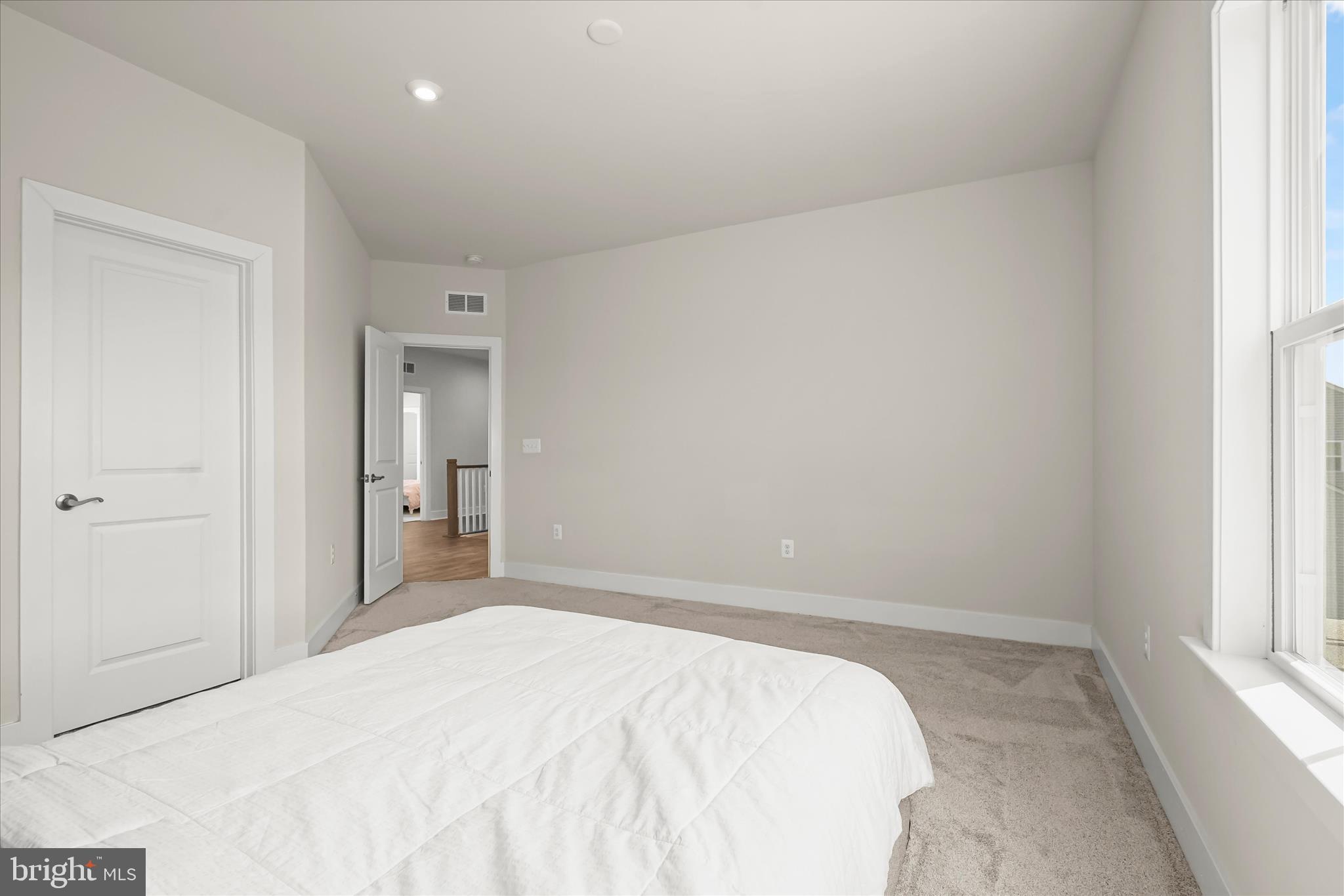 7306 Sugar Magnolia Loop Gainesville, VA 20155 - Photo 47 of 71 a bedroom with a bed and a window
