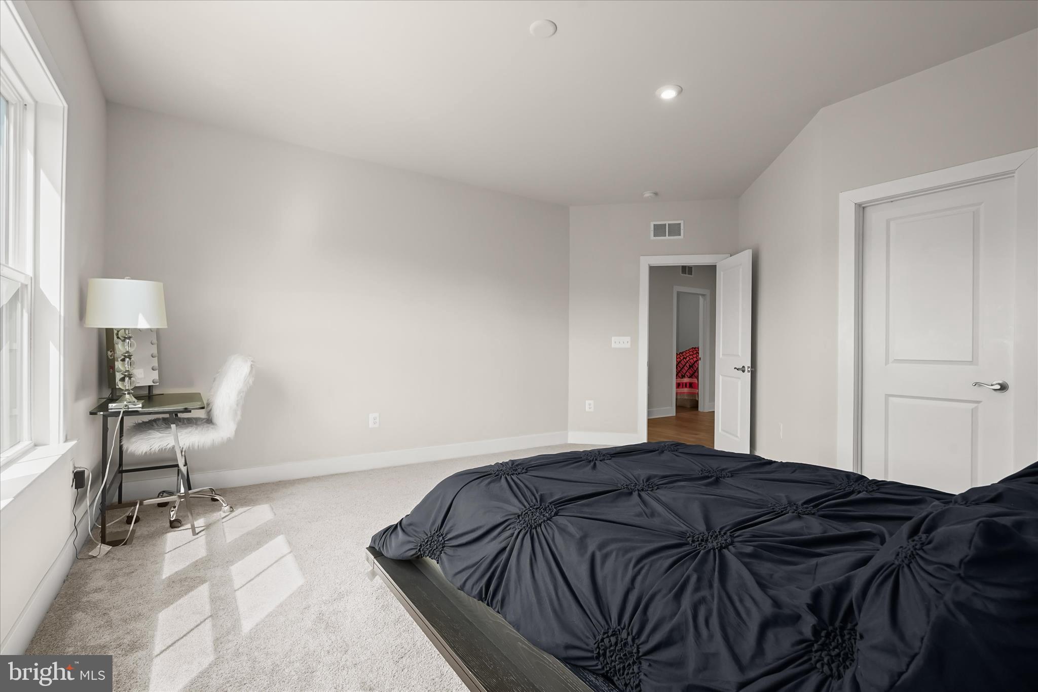7306 Sugar Magnolia Loop Gainesville, VA 20155 - Photo 49 of 71 a bedroom with a bed and a chair