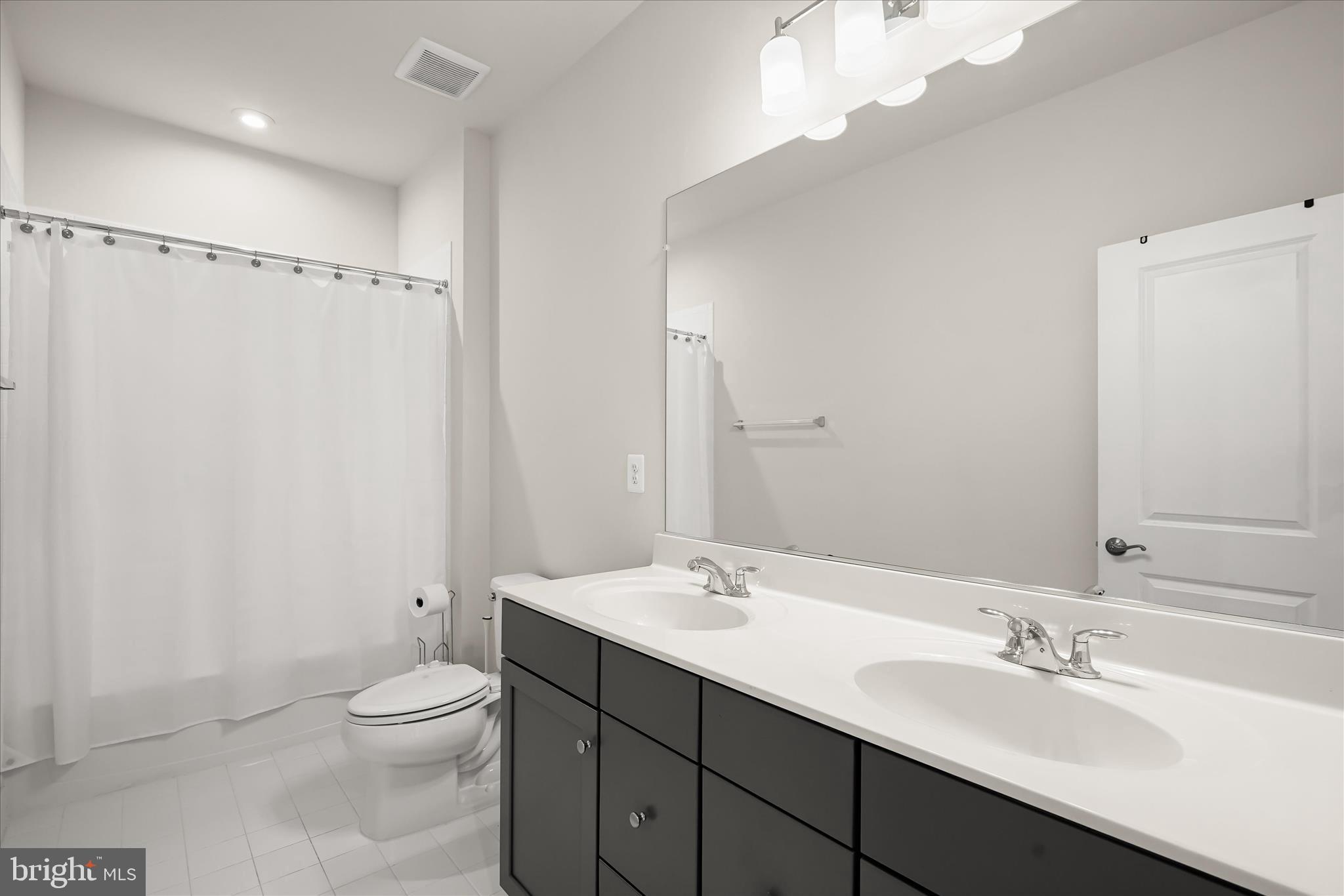 7306 Sugar Magnolia Loop Gainesville, VA 20155 - Photo 50 of 71 a bathroom with a sink a toilet and shower