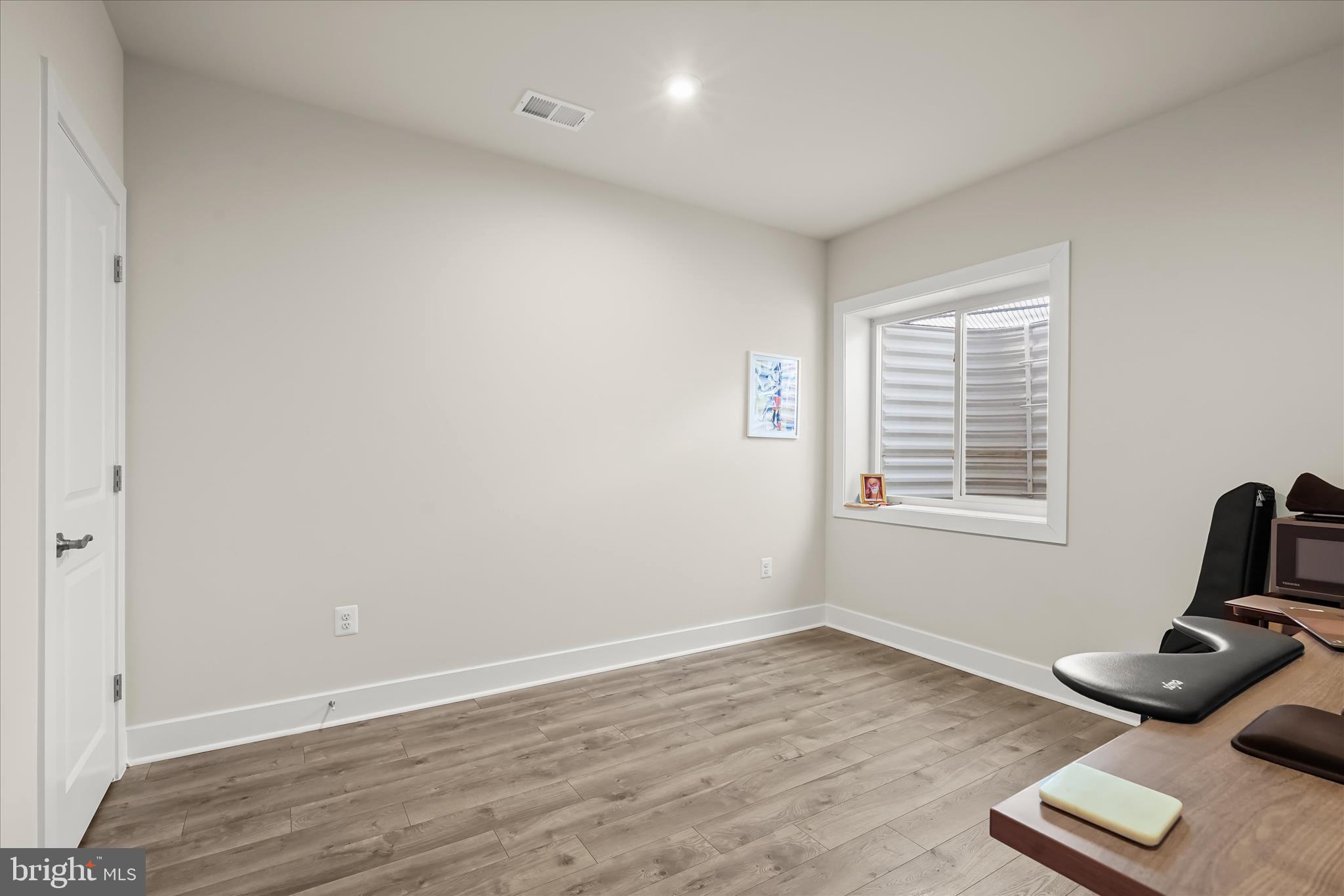 7306 Sugar Magnolia Loop Gainesville, VA 20155 - Photo 55 of 71 a view of a room with a window and wooden floor