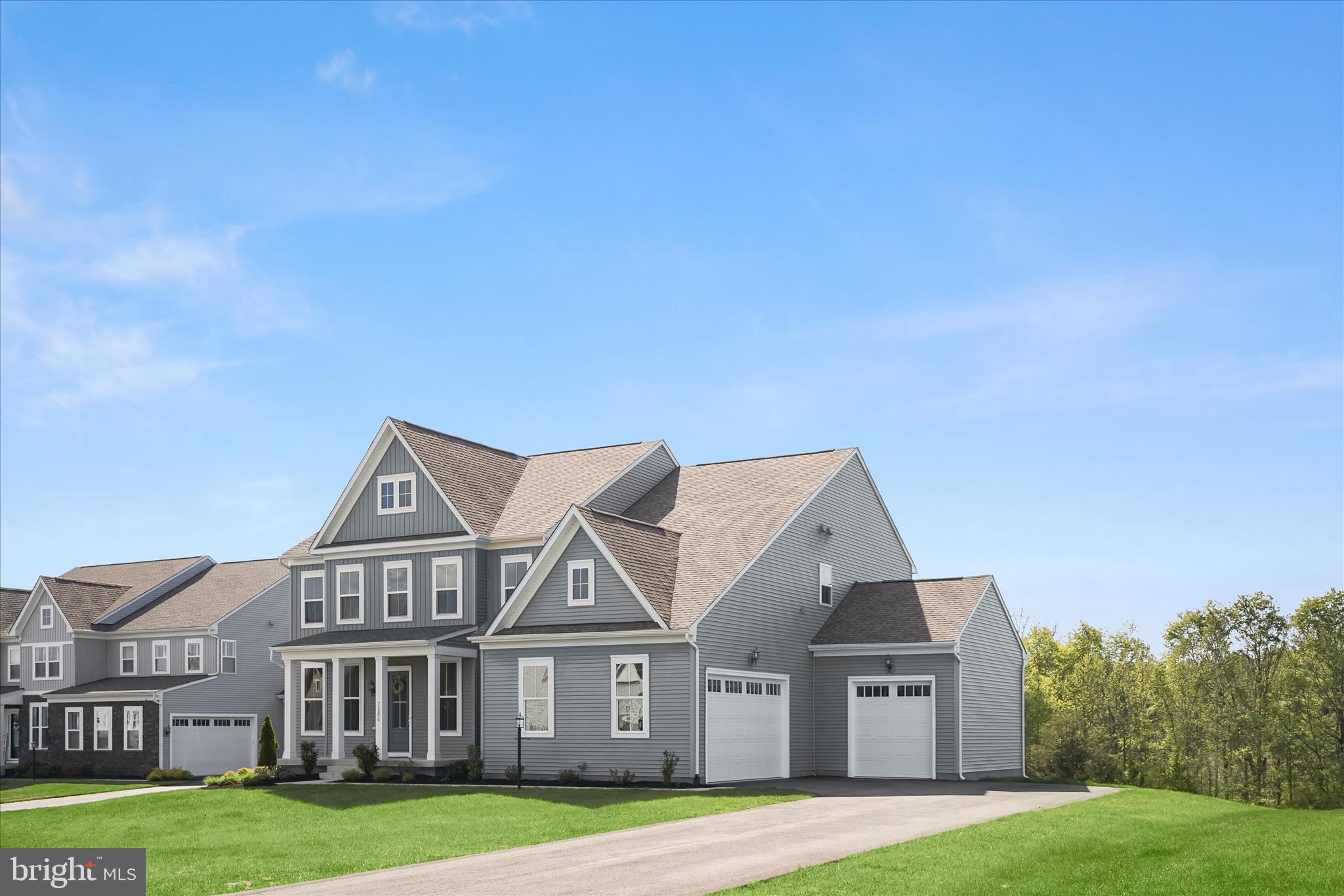 7306 Sugar Magnolia Loop Gainesville, VA 20155 - Photo 57 of 71 a front view of a house with a yard