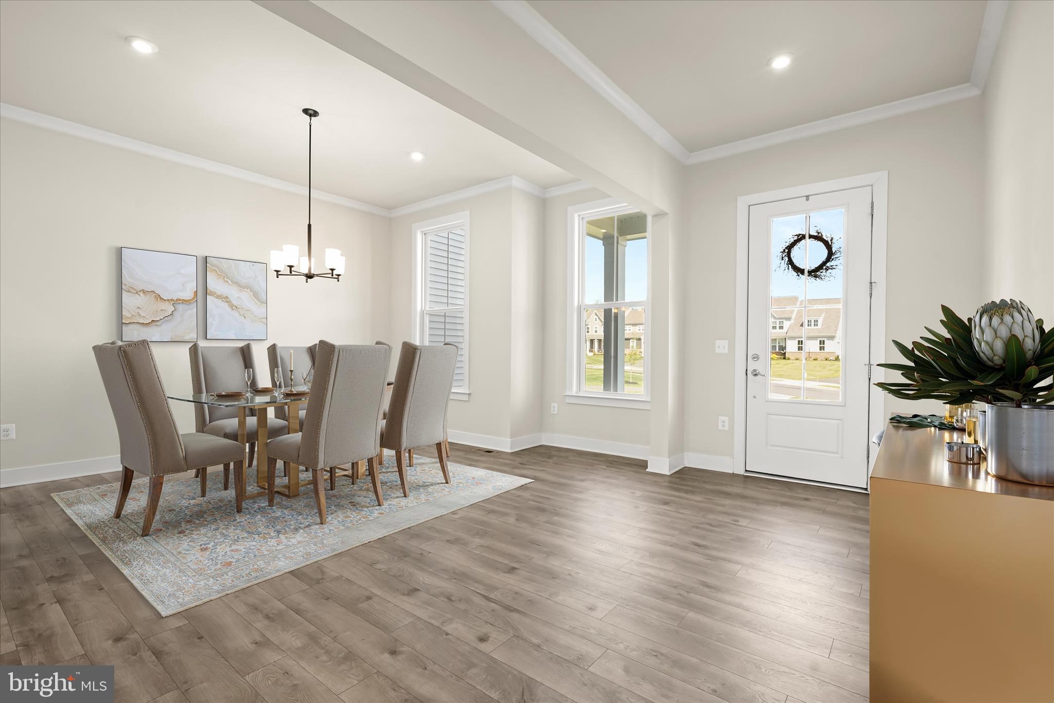 7306 Sugar Magnolia Loop Gainesville, VA 20155 - Photo 6 of 71 a view of a dining room with furniture window and wooden floor