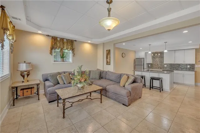 a living room with furniture and kitchen view