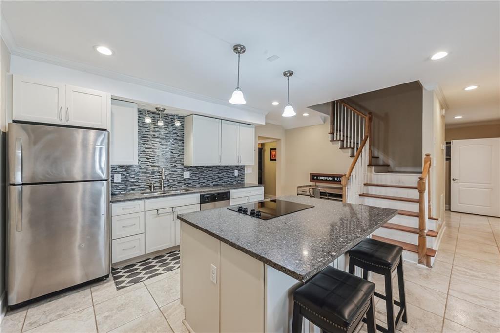 4152 Yearling Way Lithonia, GA 30038 - Photo 4 of 13 a kitchen with stainless steel appliances granite countertop a sink refrigerator and cabinets