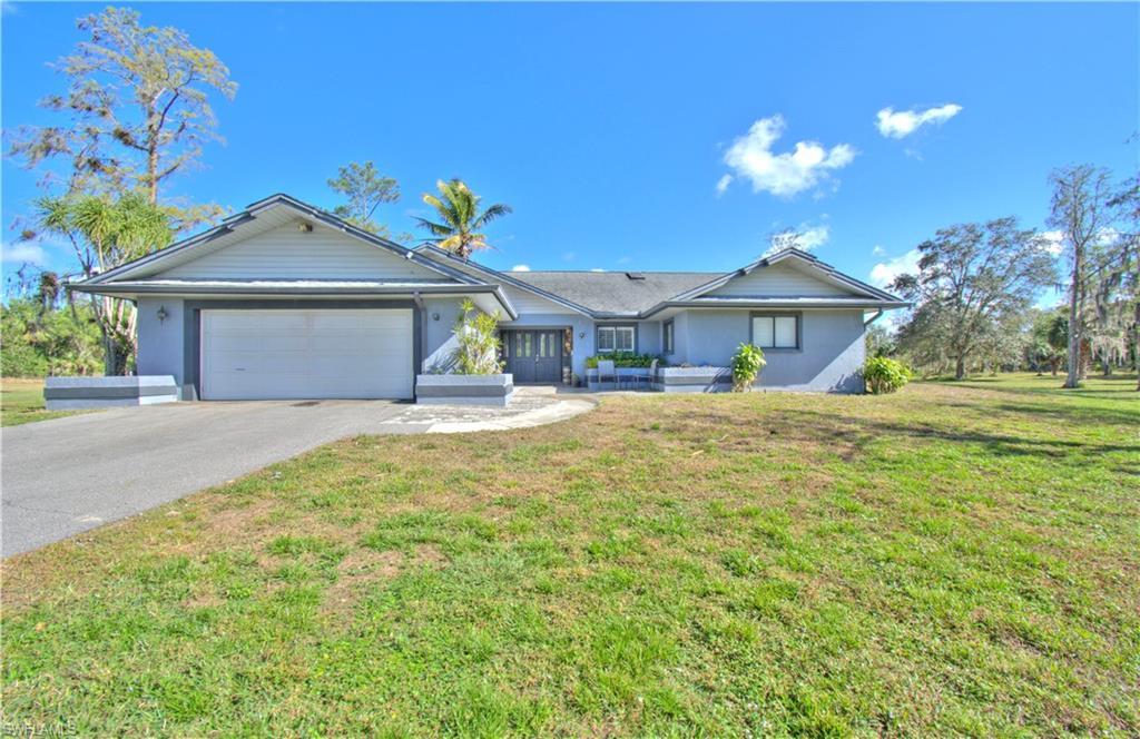 2600 Garland Road Naples, FL 34117 - Photo 1 of 34 a front view of a house with a yard