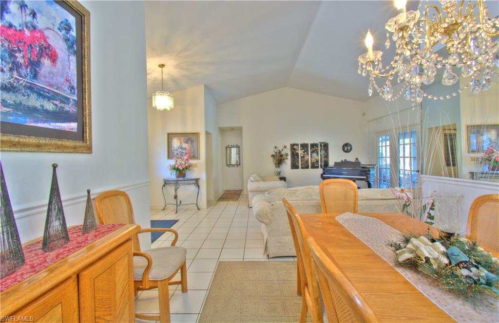 2600 Garland Road Naples, FL 34117 - Photo 11 of 34 a living room with furniture and a chandelier