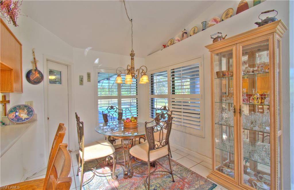 2600 Garland Road Naples, FL 34117 - Photo 15 of 34 a view of a dining room with furniture large windows and wooden floor