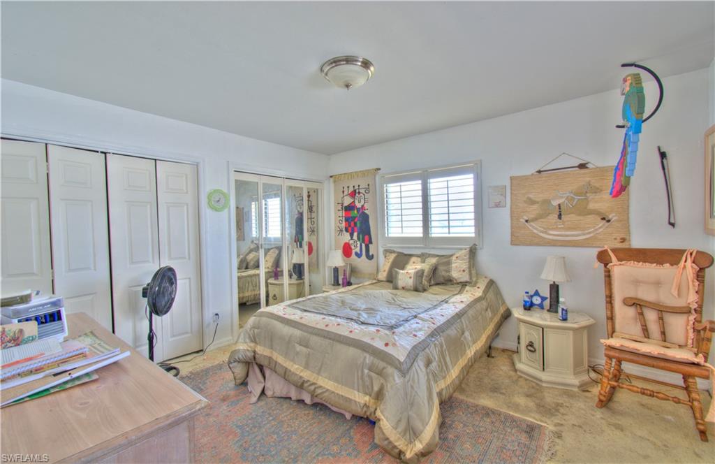 2600 Garland Road Naples, FL 34117 - Photo 20 of 34 a bedroom with a bed table and a window