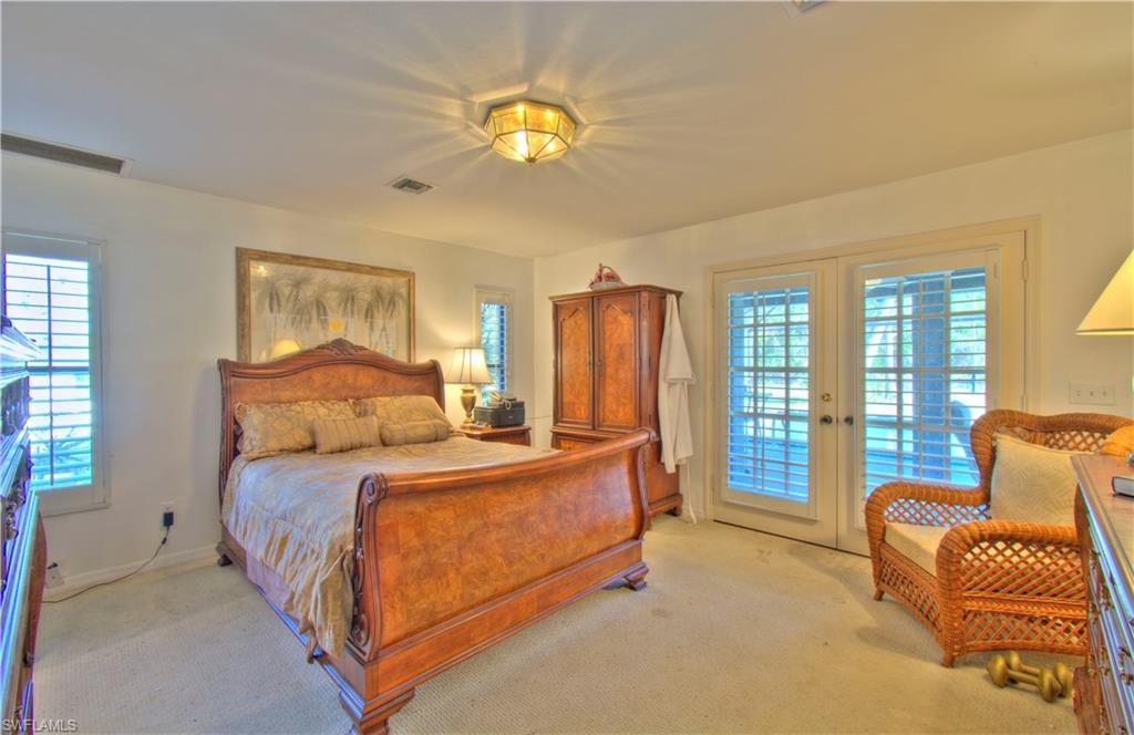 2600 Garland Road Naples, FL 34117 - Photo 23 of 34 a bedroom with bed and a couch