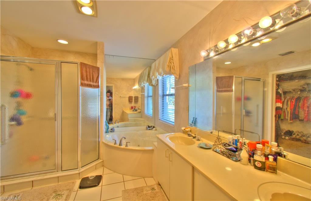 2600 Garland Road Naples, FL 34117 - Photo 24 of 34 a bathroom with a tub sink and mirror