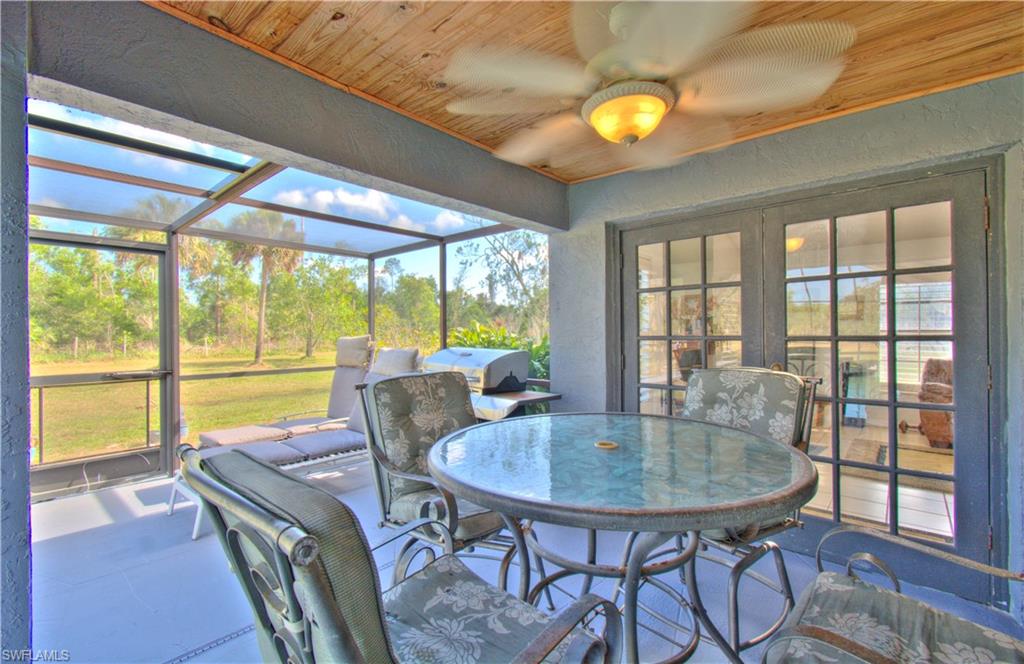 2600 Garland Road Naples, FL 34117 - Photo 25 of 34 a dining room with furniture and wooden floor