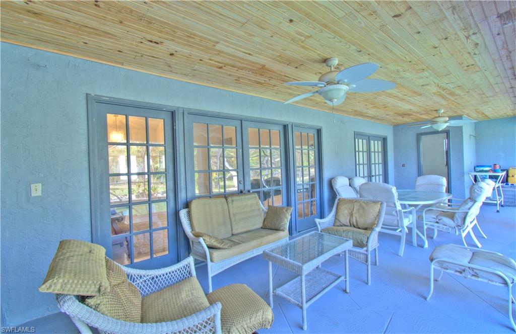 2600 Garland Road Naples, FL 34117 - Photo 26 of 34 a living room with furniture and a large window