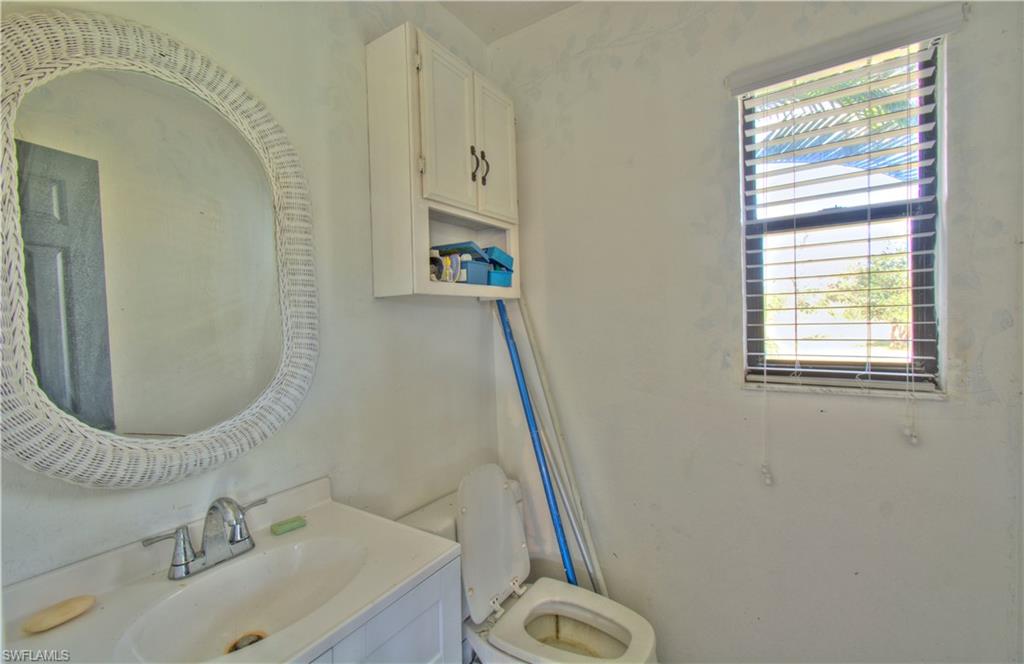 2600 Garland Road Naples, FL 34117 - Photo 28 of 34 a bathroom with a sink and a mirror