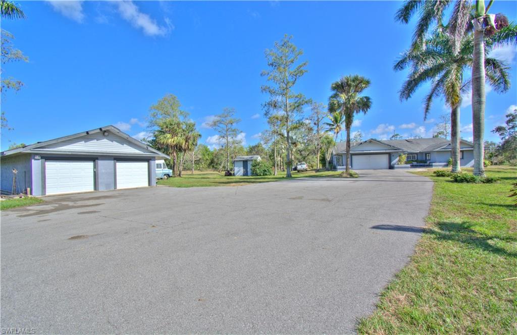 2600 Garland Road Naples, FL 34117 - Photo 3 of 34 a front view of a house with a yard and garage