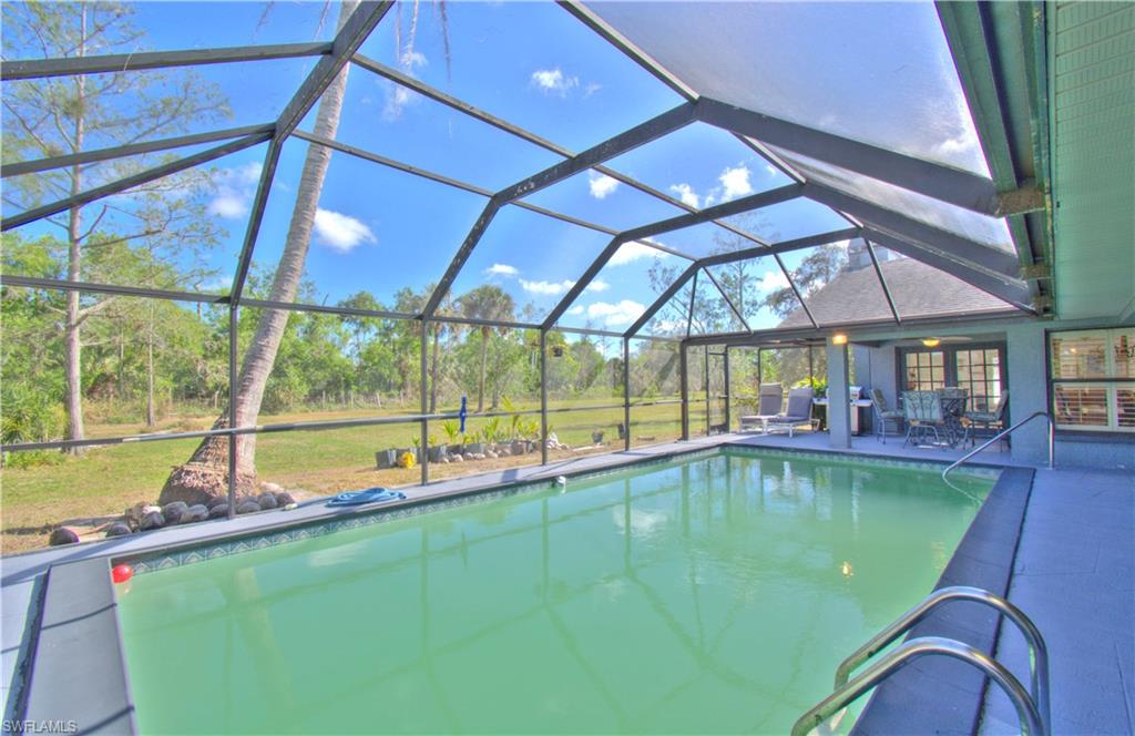 2600 Garland Road Naples, FL 34117 - Photo 31 of 34 a view of a backyard with a swimming pool