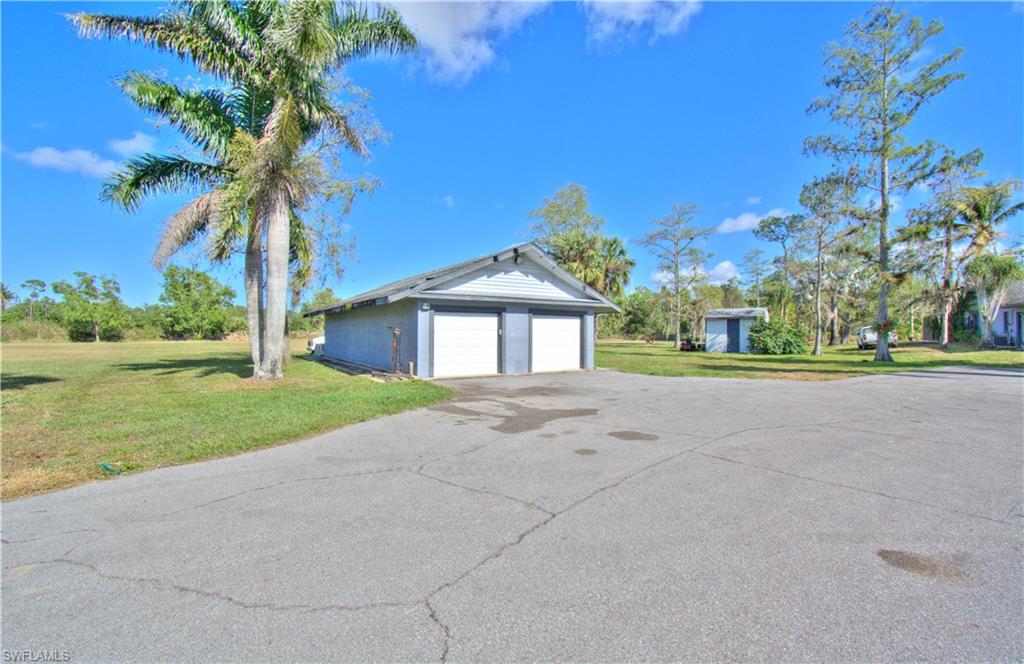 2600 Garland Road Naples, FL 34117 - Photo 4 of 34 a front view of a house with a yard and garage