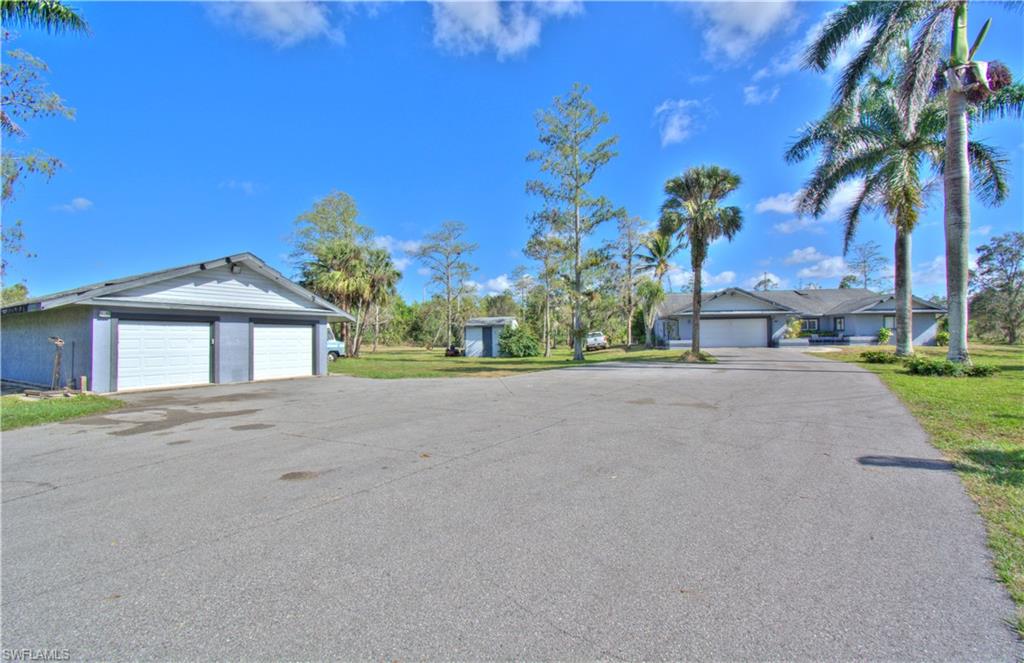 2600 Garland Road Naples, FL 34117 - Photo 5 of 34 a front view of a house with a yard and garage