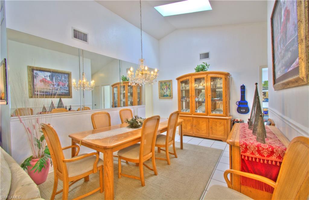 2600 Garland Road Naples, FL 34117 - Photo 10 of 34 a dining room with furniture and a chandelier