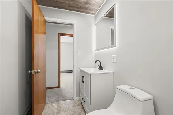 a bathroom with a toilet a sink and mirror