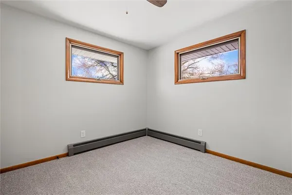 a view of an empty room with a painting on the wall