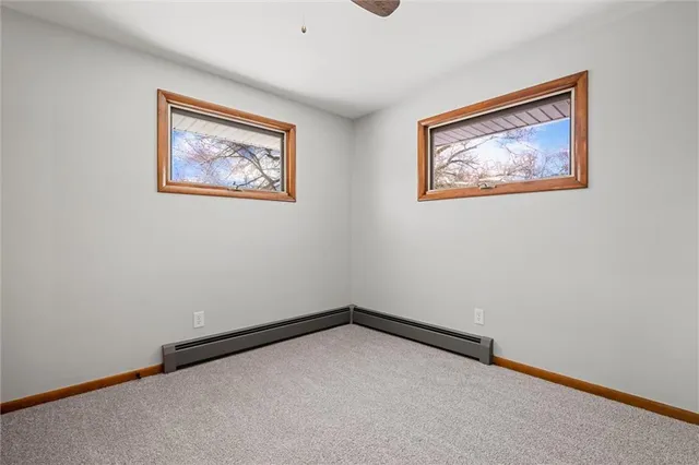 a view of an empty room with a painting on the wall