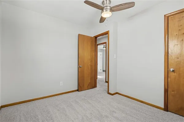 a view of a room with a ceiling fan