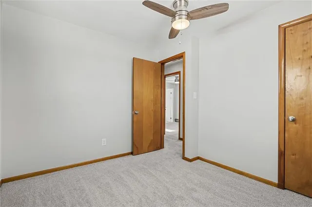a view of a room with a ceiling fan