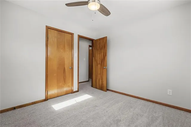 an empty room with a empty space and chandelier fan