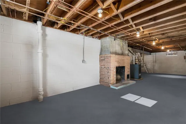a view of an empty room with a fireplace