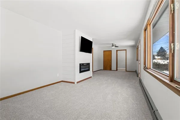 a view of a livingroom with an empty space and a fireplace