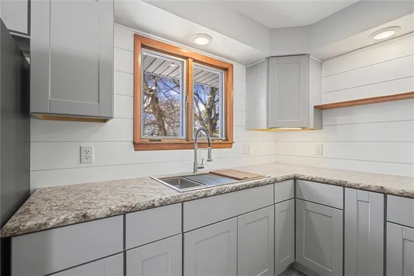 a kitchen with a sink and cabinets