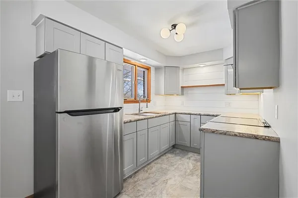 a kitchen with a refrigerator sink stove and cabinets